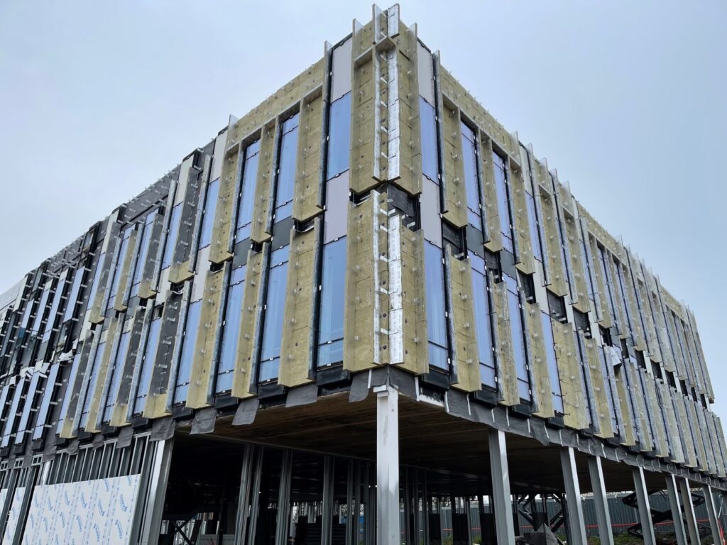 Modern building under construction with metal and glass facade
