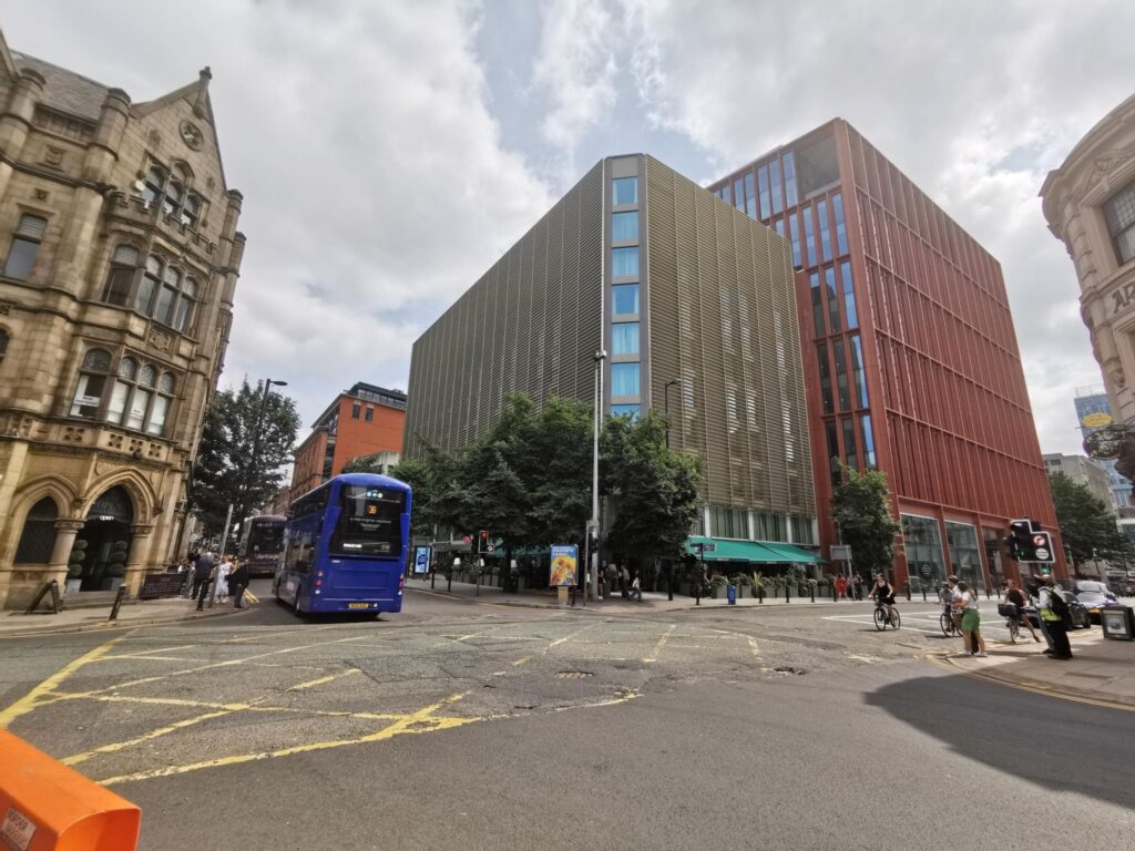 Street view of urban architecture with people and blue bus