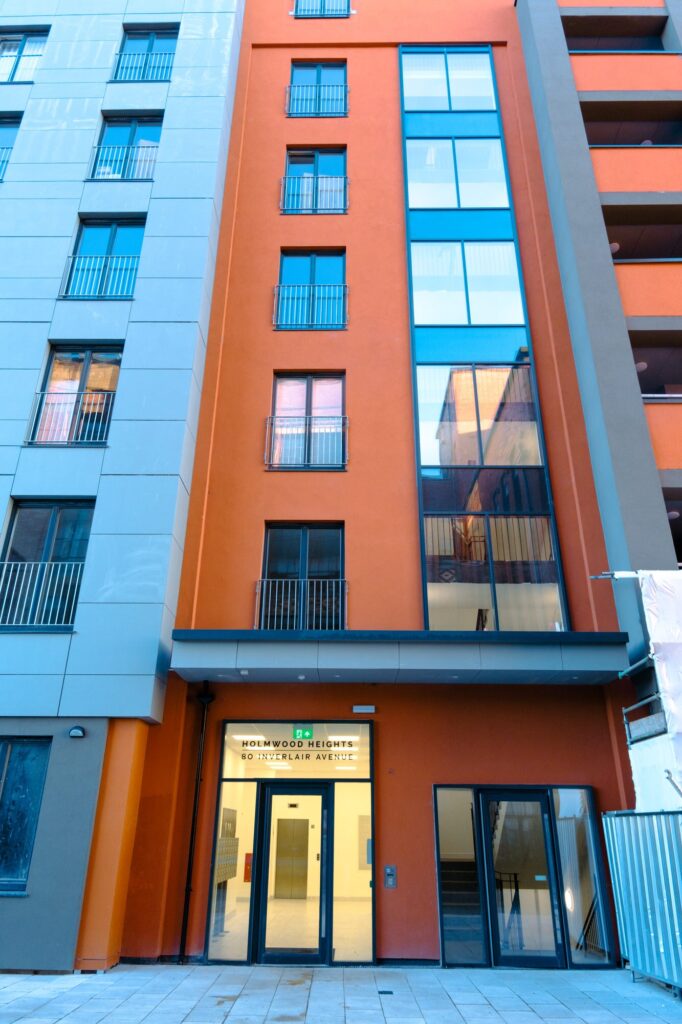 Modern apartment building with orange facade and large windows
