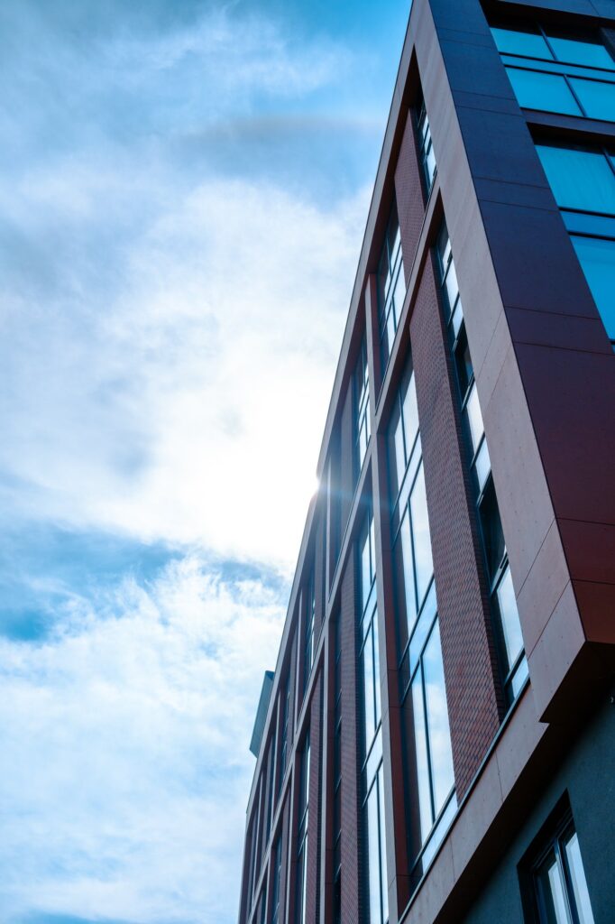 Modern building against bright sky with sunlight in background