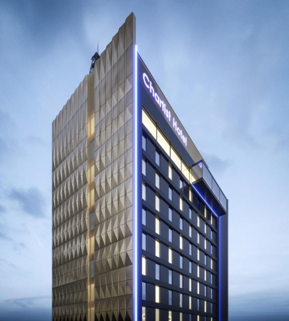 Modern tall hotel building with reflective glass exterior.