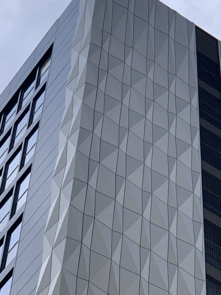 Modern building with geometric facade against clear sky