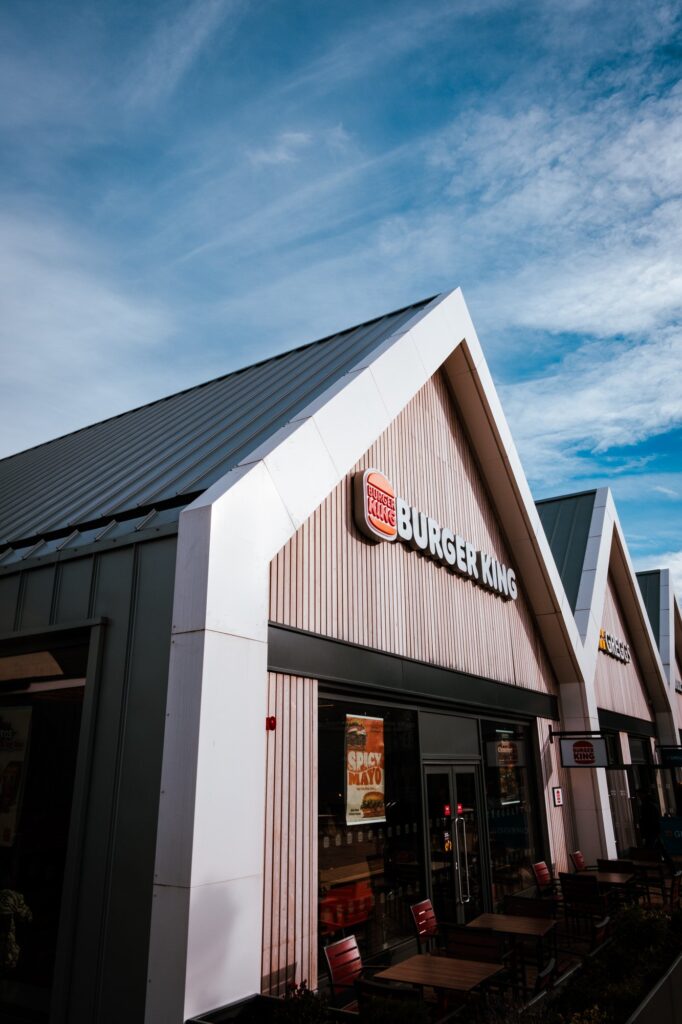 Modern Burger King restaurant with outdoor seating under blue sky