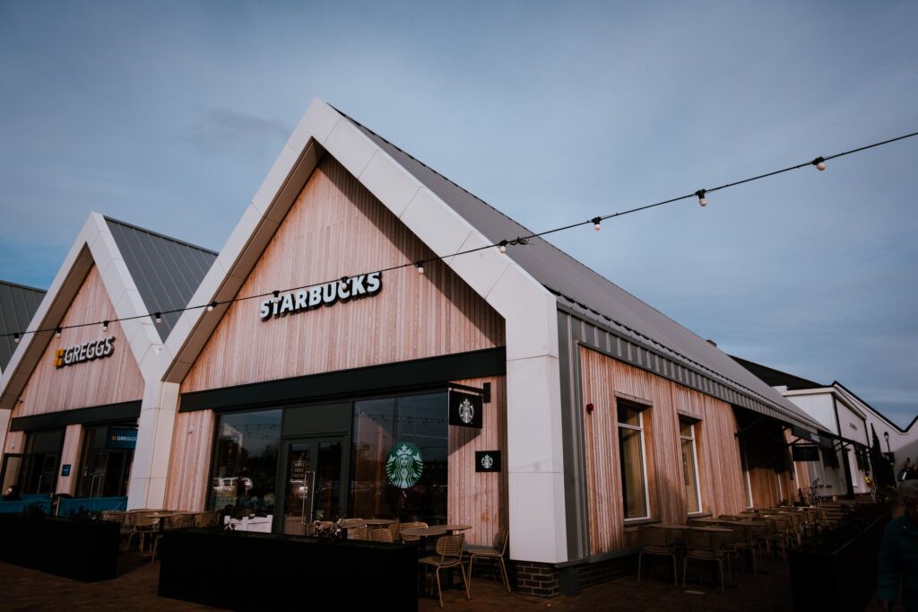 Modern Starbucks exterior with wooden design and outdoor seating