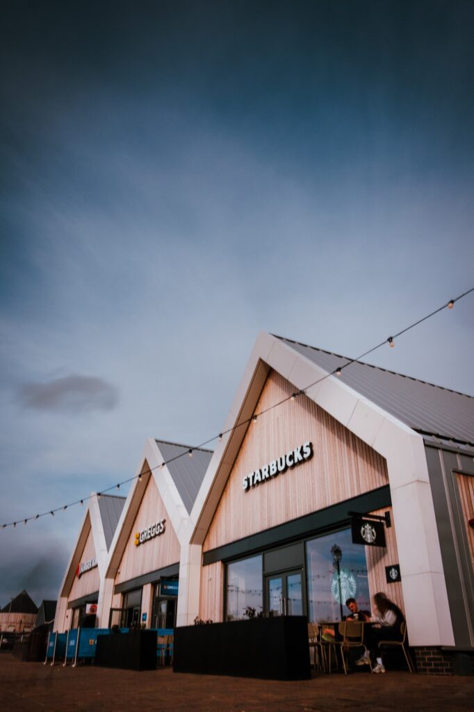 Modern cafe exterior with gabled roofs on a cloudy day