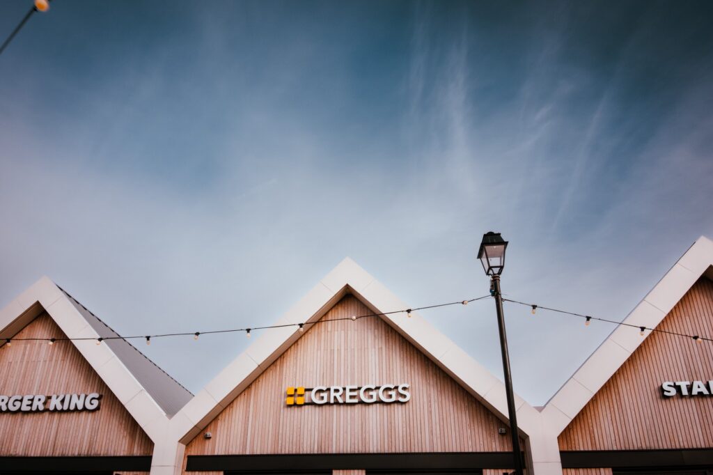 Modern storefronts against a clear blue sky.