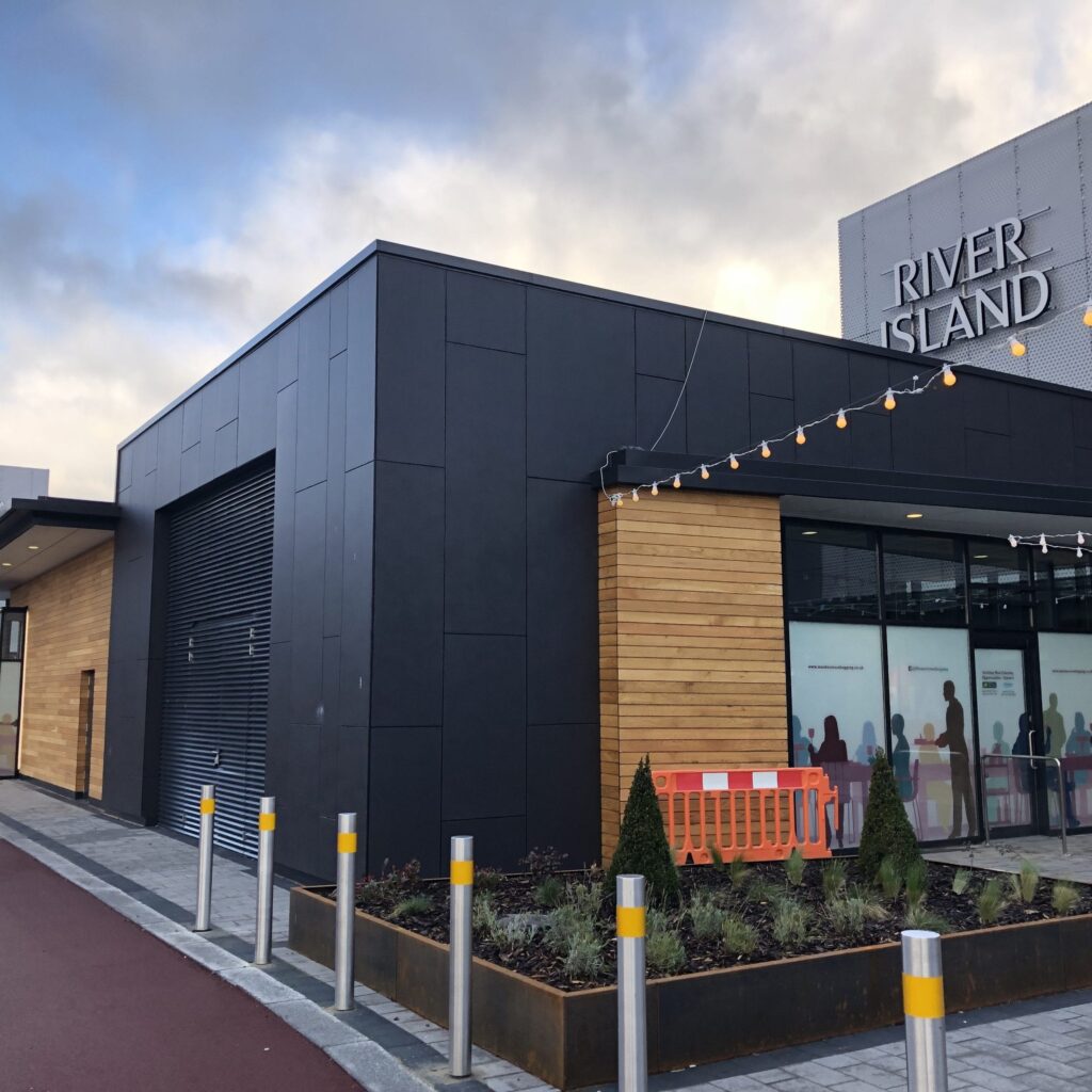 Modern retail storefront with glass entrance and signage