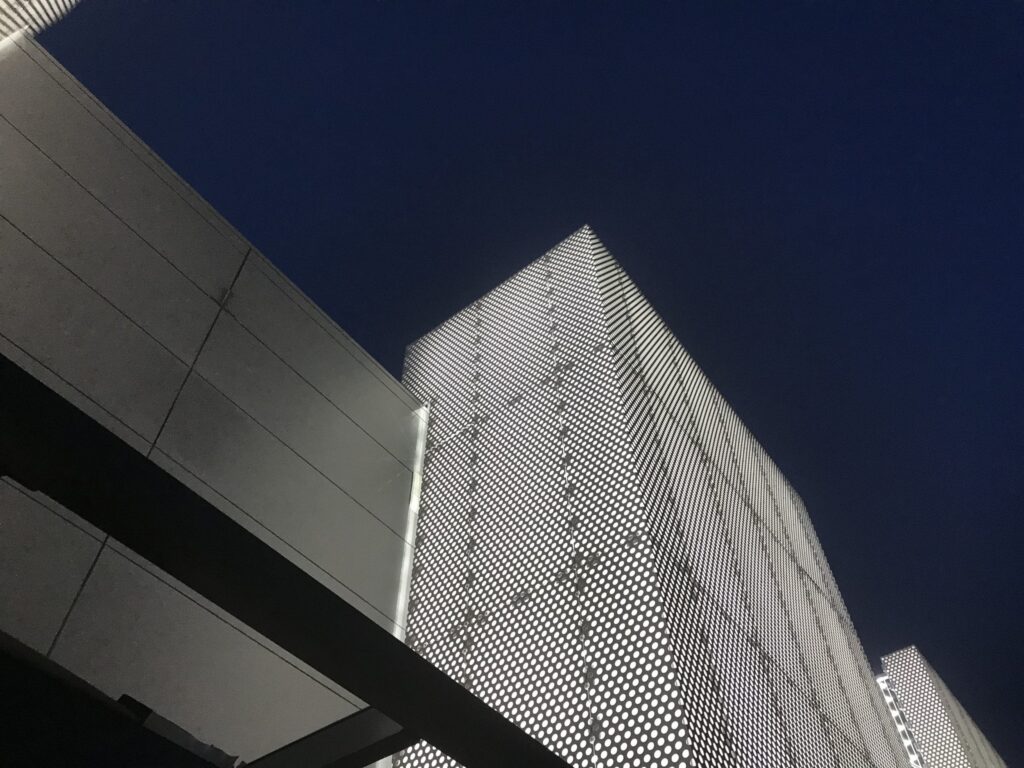 Modern architectural building with illuminated facade at night