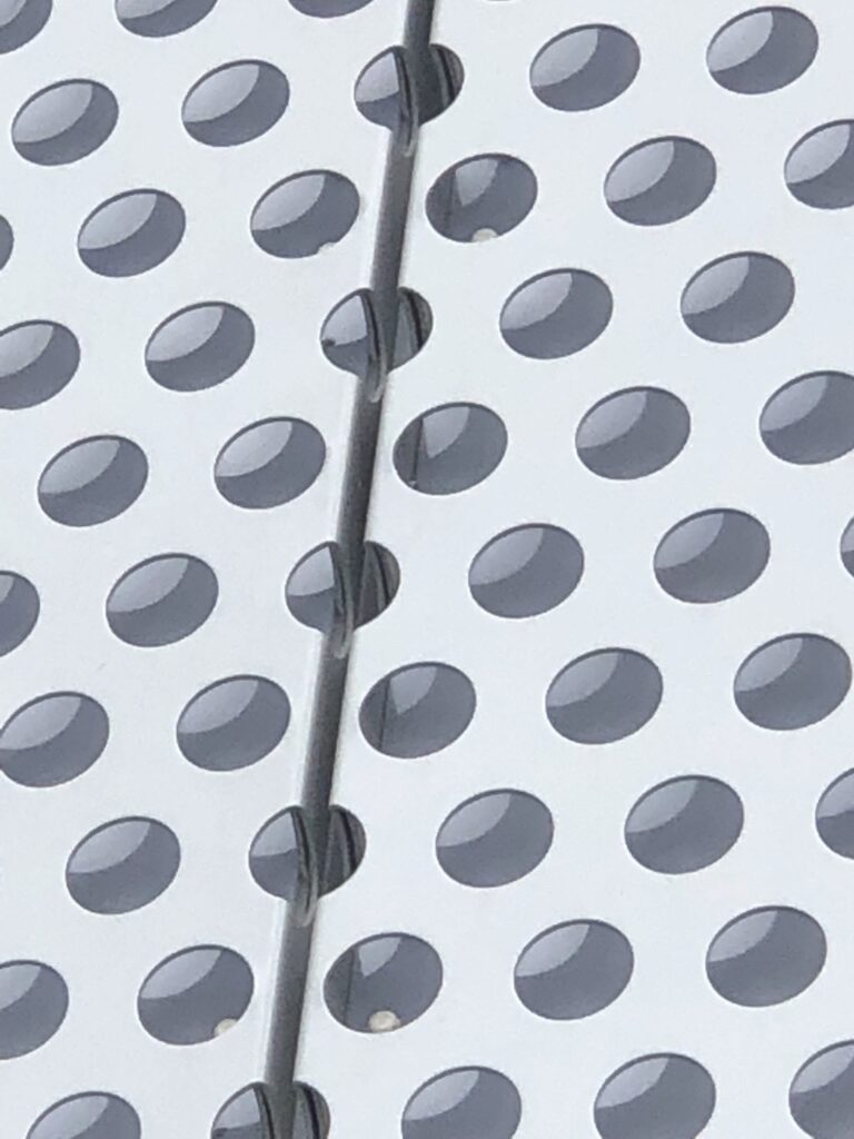Perforated metal sheet with circular holes close up view
