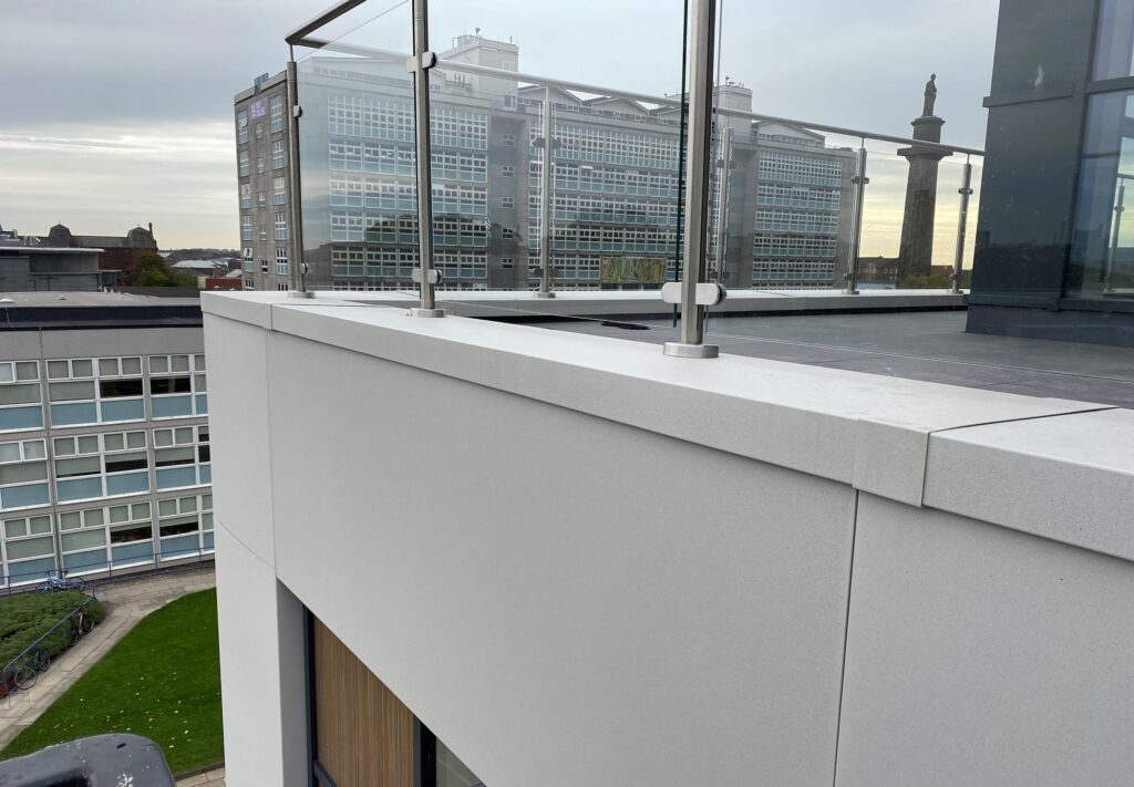 Modern rooftop terrace with glass railing and city view